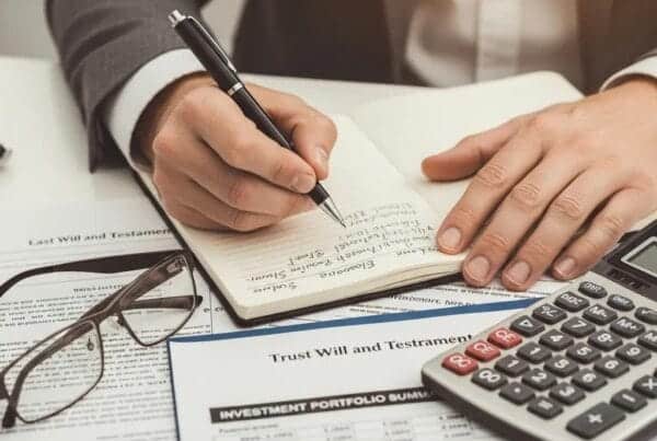 Close-up of hands documenting fiduciary duties with trust documents